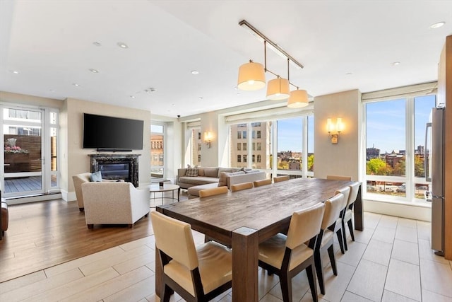 dining room featuring recessed lighting and a glass covered fireplace