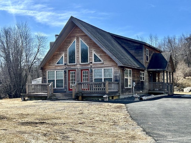 view of front of property with a deck and a chimney