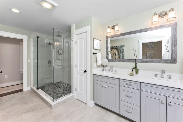 bathroom with a shower with door and vanity