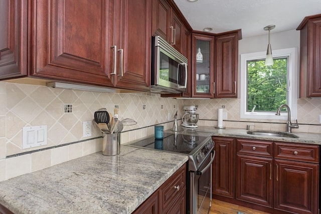 194 Crossfield Rd, Franklin, MA 02038 - kitchen with appliances with stainless steel finishes, dark brown cabinets, decorative light fixtures, and light stone countertops