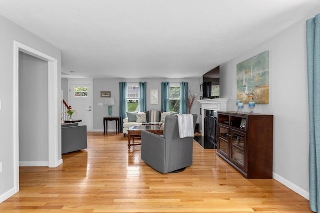194 Crossfield Rd, Franklin, MA 02038 - living area featuring light wood-type flooring, healthy amount of natural light, stairway, and a fireplace with flush hearth