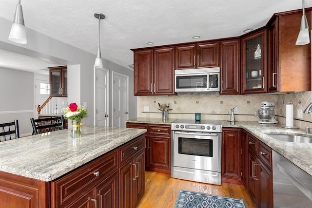 194 Crossfield Rd, Franklin, MA 02038 - kitchen featuring stainless steel appliances, light wood finished floors, light stone countertops, backsplash, and recessed lighting
