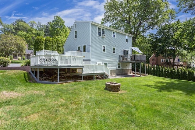 194 Crossfield Rd, Franklin, MA 02038 - back of house featuring a fire pit, a deck, and a lawn
