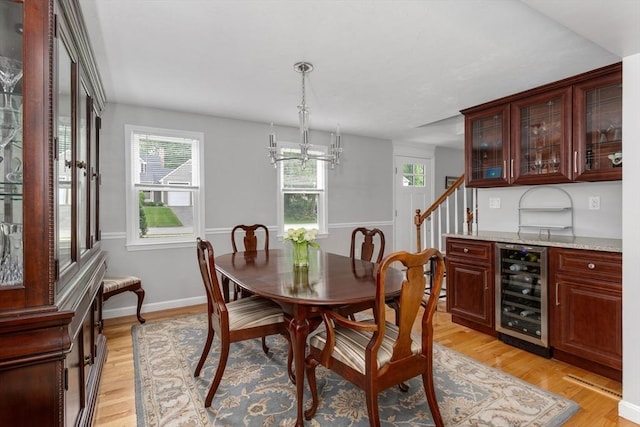 194 Crossfield Rd, Franklin, MA 02038 - dining area featuring beverage cooler, light wood-style flooring, and a chandelier