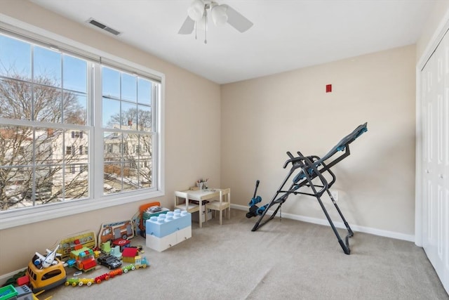 playroom featuring light colored carpet and ceiling fan