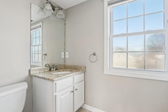 bathroom featuring toilet and vanity