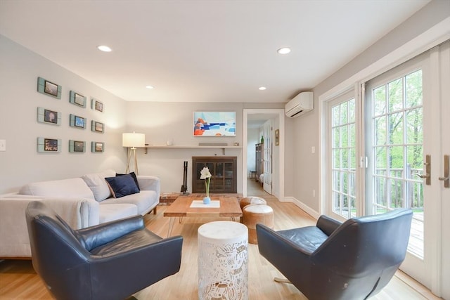 living area featuring a wall mounted AC, light wood-style floors, and recessed lighting