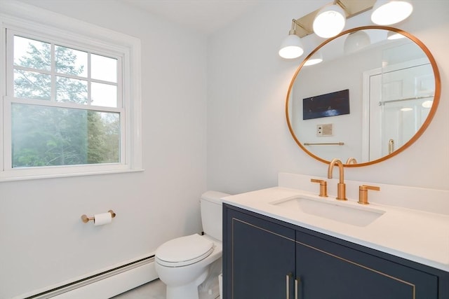 half bathroom featuring a baseboard radiator, toilet, and vanity