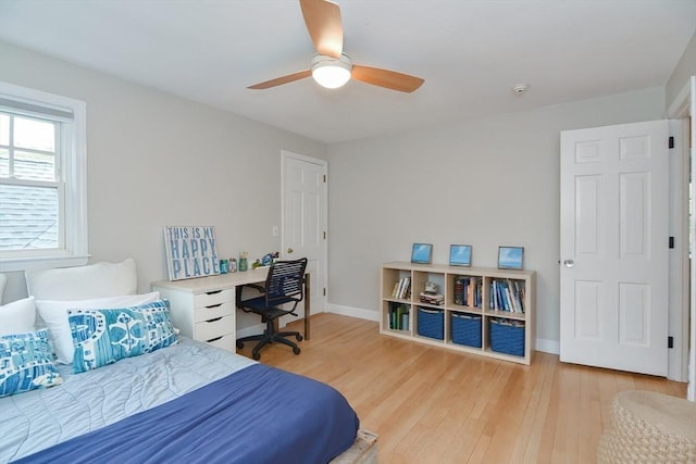 bedroom with wood finished floors, baseboards, and ceiling fan