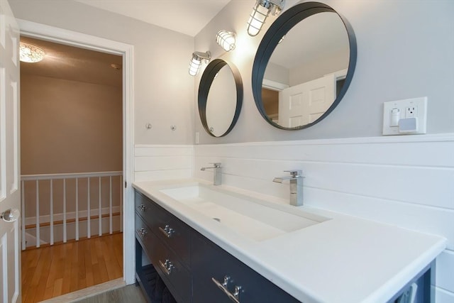bathroom with wood finished floors and vanity
