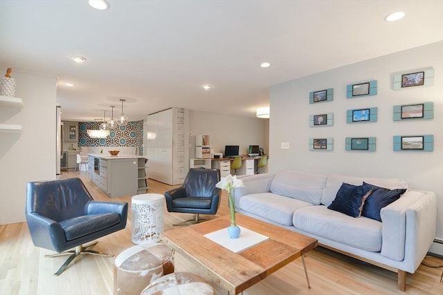 living area with light wood finished floors and recessed lighting
