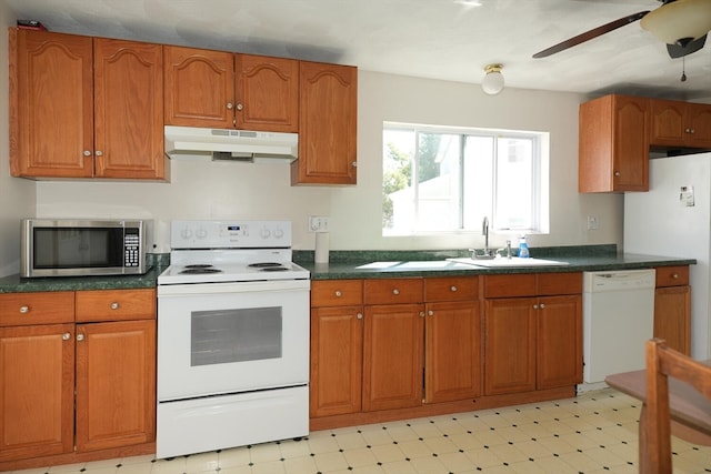 kitchen featuring white appliances, sink, and ceiling fan