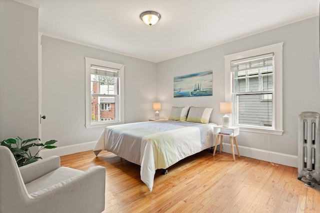17-19 Newtonville Ave Unit 2, Newton, MA 02458 - bedroom with radiator, baseboards, and light wood-style flooring
