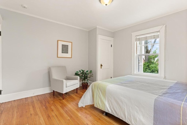 17-19 Newtonville Ave Unit 2, Newton, MA 02458 - bedroom with ornamental molding, baseboards, and light wood finished floors