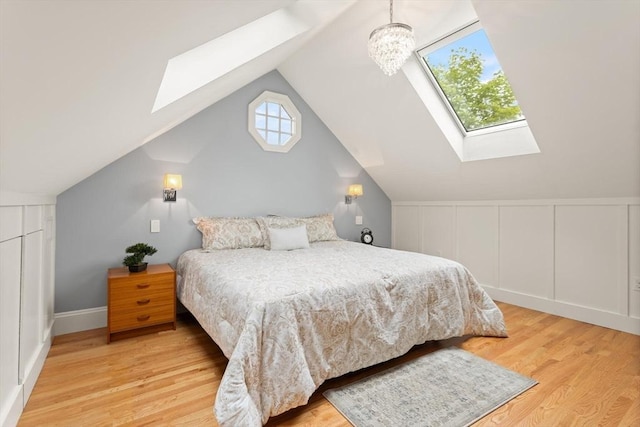 17-19 Newtonville Ave Unit 2, Newton, MA 02458 - bedroom featuring a skylight, lofted ceiling, wood finished floors, and a decorative wall
