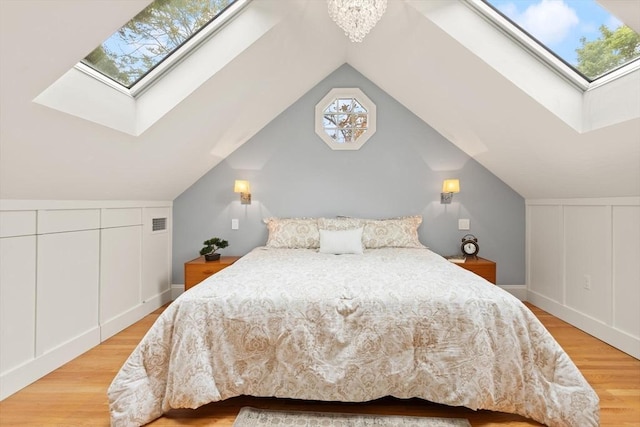 17-19 Newtonville Ave Unit 2, Newton, MA 02458 - bedroom featuring a skylight, wood finished floors, and lofted ceiling