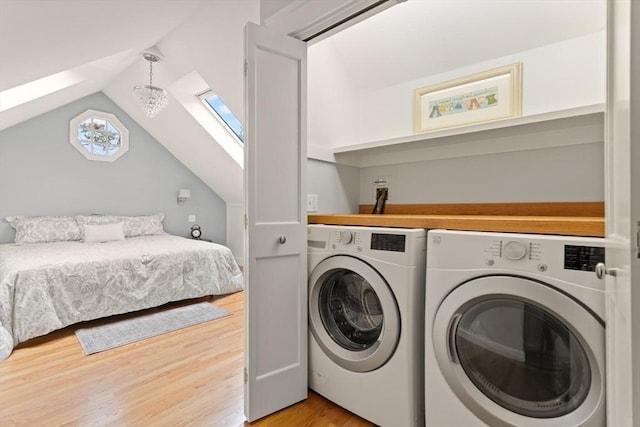 17-19 Newtonville Ave Unit 2, Newton, MA 02458 - laundry room featuring washing machine and clothes dryer, light wood-type flooring, and a skylight