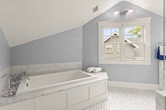 17-19 Newtonville Ave Unit 2, Newton, MA 02458 - bathroom featuring vaulted ceiling, a bath, and baseboards