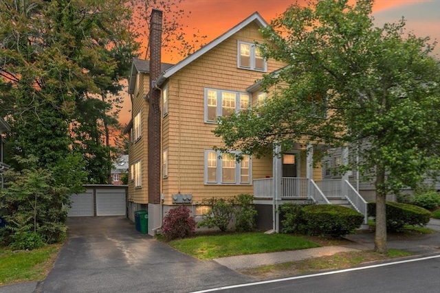 17-19 Newtonville Ave Unit 2, Newton, MA 02458 - view of front of home with an outdoor structure, a garage, and covered porch