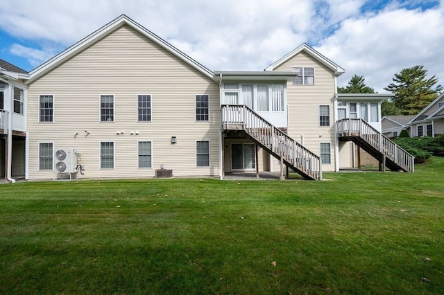 rear view of house with a lawn and ac unit