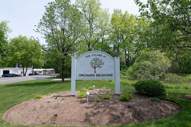 community / neighborhood sign with a lawn