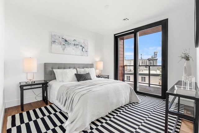 1515 Commonwealth Ave Unit 211, Boston, MA 02135 - bedroom with access to outside, wood finished floors, and baseboards
