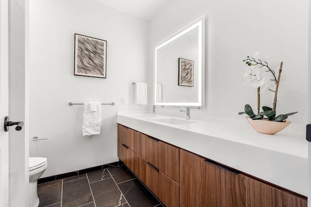 1515 Commonwealth Ave Unit 211, Boston, MA 02135 - full bath with double vanity, toilet, baseboards, and marble finish floors