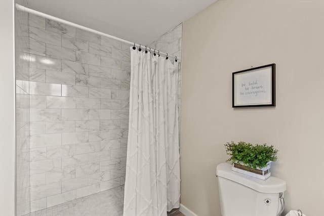 bathroom with a shower with curtain and toilet