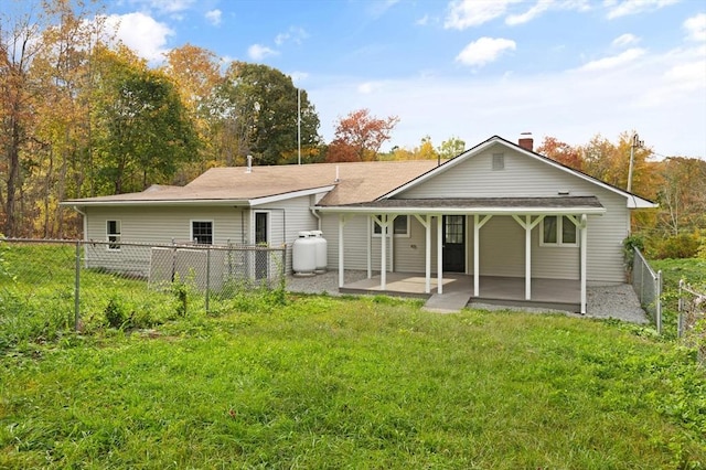 back of house featuring a yard and a patio area