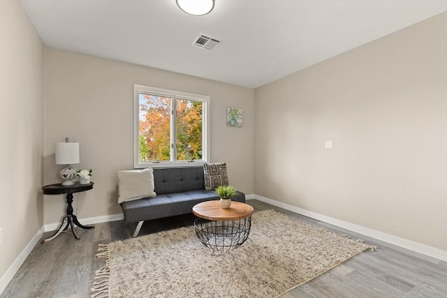 living area with hardwood / wood-style flooring