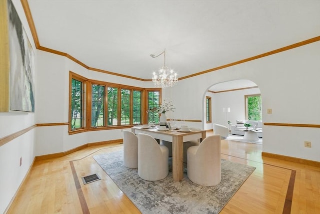 9 Buffalo Run, Southborough, MA 01772 - dining room featuring arched walkways, hardwood / wood-style floors, a chandelier, and ornamental molding