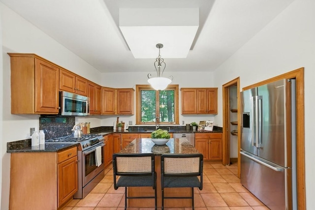 9 Buffalo Run, Southborough, MA 01772 - kitchen featuring stainless steel appliances, brown cabinets, dark stone countertops, and decorative light fixtures