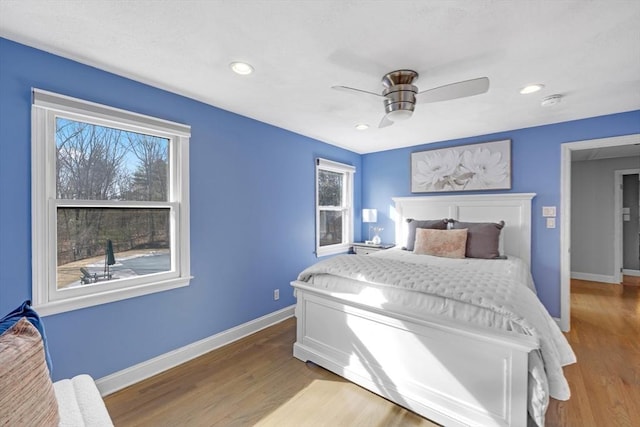 bedroom featuring recessed lighting, a ceiling fan, baseboards, and wood finished floors