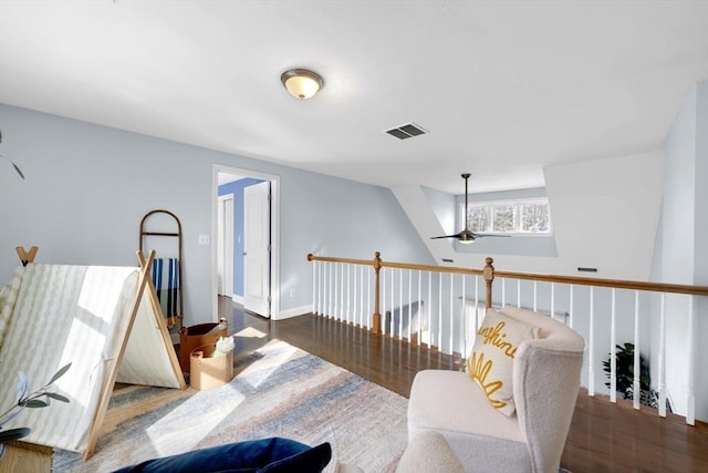 sitting room featuring wood finished floors, visible vents, and baseboards