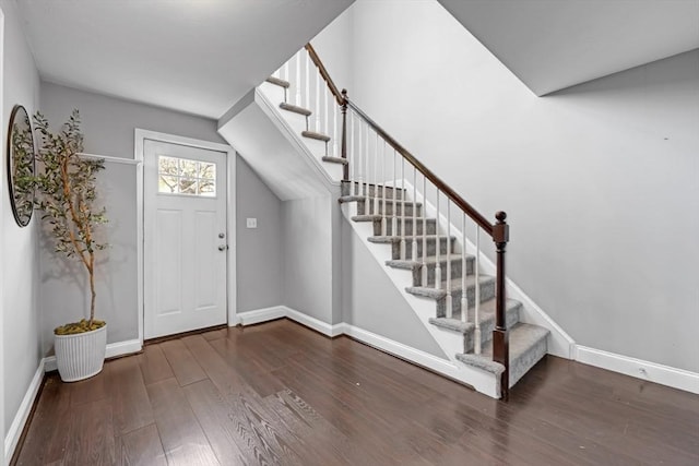 foyer with stairway, baseboards, and wood finished floors