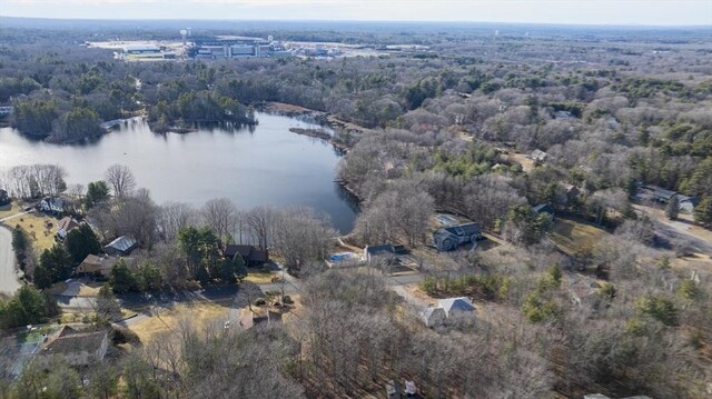 drone / aerial view featuring a wooded view and a water view