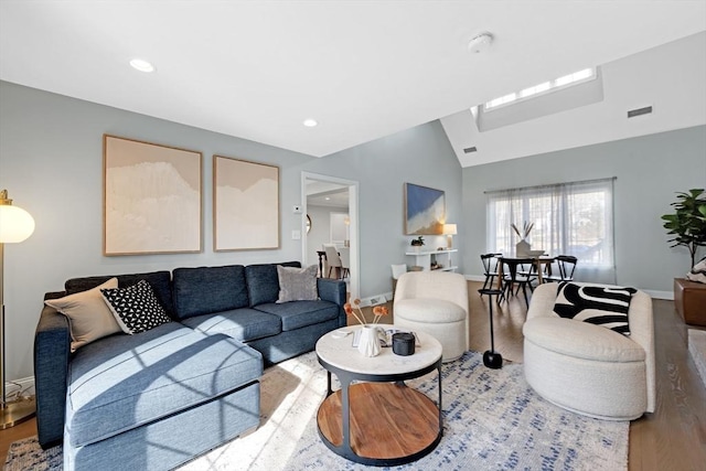 living room featuring lofted ceiling, recessed lighting, wood finished floors, and baseboards