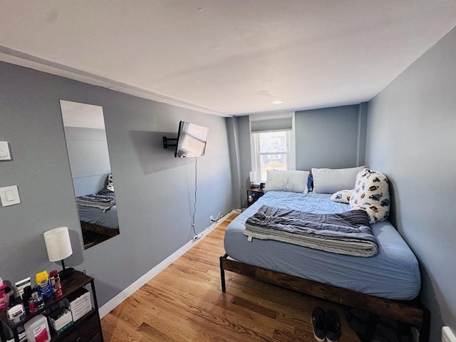 bedroom featuring light wood-style flooring and baseboards