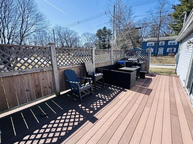 deck with a grill and fence