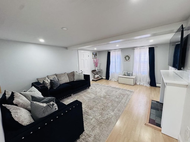 living area featuring recessed lighting, baseboard heating, and light wood-style flooring