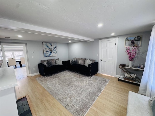 living area featuring recessed lighting, light wood-type flooring, and baseboards