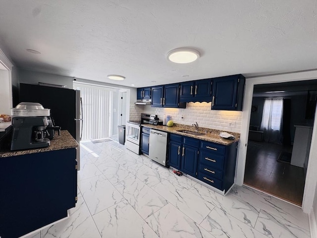 kitchen featuring marble finish floor, blue cabinetry, a sink, under cabinet range hood, and appliances with stainless steel finishes