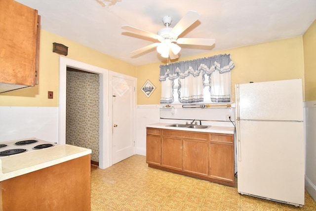 81 Osborne Ter, Springfield, MA 01104 - kitchen featuring freestanding refrigerator, cooktop, ceiling fan, a wainscoted wall, and light flooring