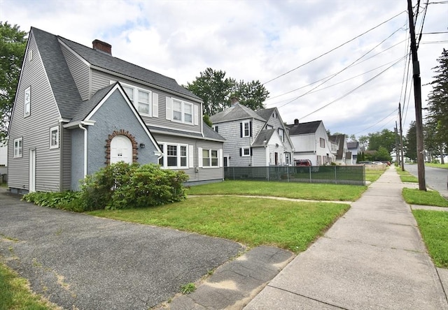 81 Osborne Ter, Springfield, MA 01104 - view of front facade with roof with shingles, a chimney, and a residential view