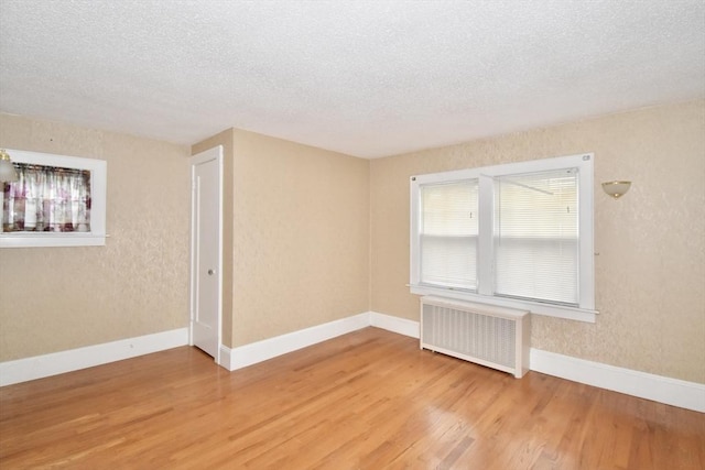 81 Osborne Ter, Springfield, MA 01104 - spare room with radiator, wood finished floors, and a textured ceiling