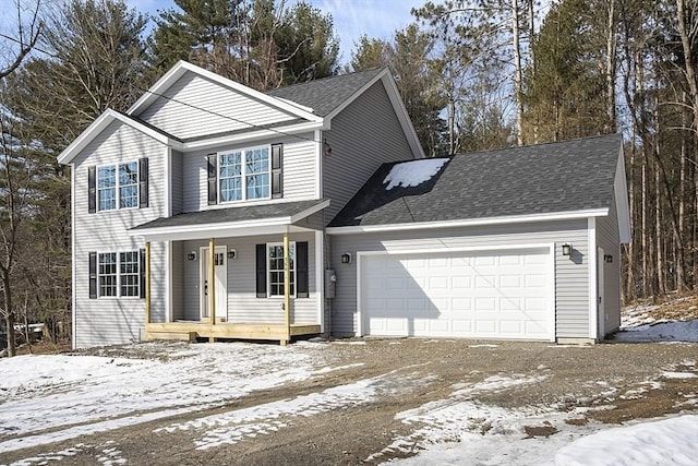 traditional-style house with a porch, a garage, a shingled roof, and driveway