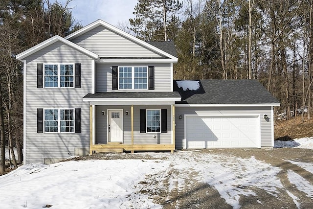 traditional-style home featuring covered porch, an attached garage, and driveway