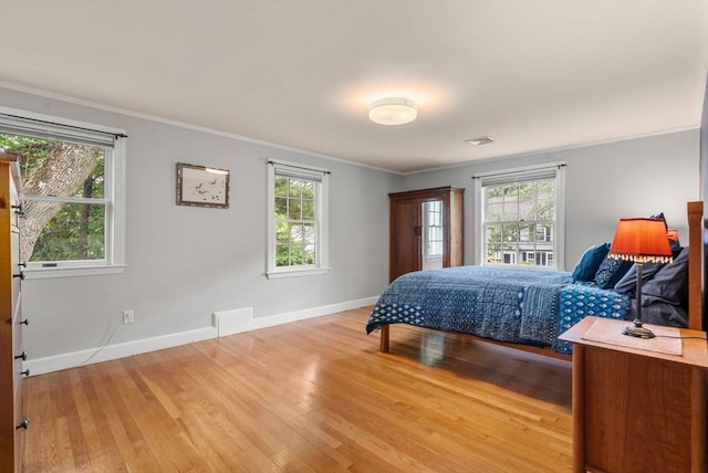 103 Randlett Park, Newton, MA 02465 - bedroom featuring multiple windows, light wood-style flooring, and ornamental molding