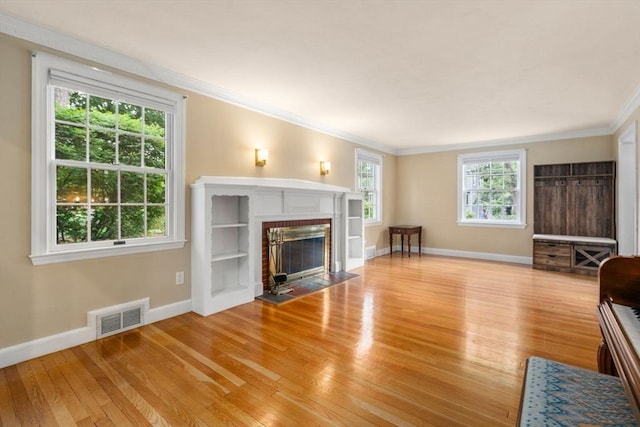 103 Randlett Park, Newton, MA 02465 - living area featuring light wood-style floors, ornamental molding, and a brick fireplace