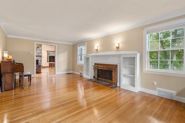 103 Randlett Park, Newton, MA 02465 - unfurnished living room with a fireplace, light wood-style floors, and ornamental molding